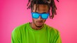 © Nataliia_Trushchenko - A man with dreadlocks and blue sunglasses is wearing a green shirt. He is looking at the camera