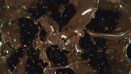Poster - Super Slow Motion of Falling Group of Chocolate Chunks. Moving Down and Splashing into Melted Chocolate. Filmed on High Speed Cinema Camera, 1000fps.