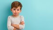 © Nataliia_Trushchenko - A young boy with a white shirt and black stripes is looking at the camera with a frown on his face