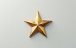 © jaykoppelman - A golden star lying flat on a light surface symbolizing achievement and excellence representing success victory and recognition in a minimalist setting