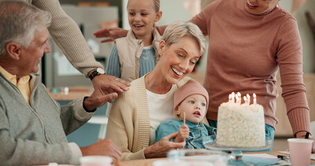 Wall Mural - Happy family, child and birthday with cake for celebration, dessert or wish together on dining table at home. Excited grandparents with grandchild or candle light for party, childhood or bonding