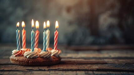 Wall Mural - Close up of birthday cake candles on wooden background