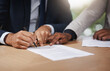 © peopleimages.com - Signature, contract and hands of business people with pen in office for b2b deal, planning or documents. Paperwork, agreement and partnership with financial advisor, client or sign up application