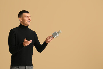 Poster - Young man with microphone on brown background