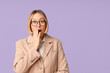 © Pixel-Shot - Shocked adult woman on lilac background