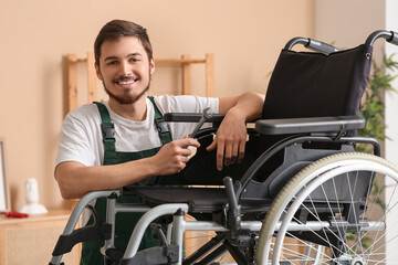 Poster - Male worker with wrench repairing wheelchair in room