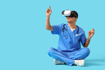 Canvas Print - Male doctor using VR glasses on blue background