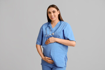 Sticker - Beautiful young pregnant doctor on grey background