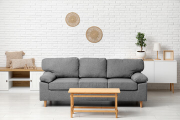 Wall Mural - Cozy sofa with coffee table in interior of living room