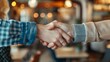 © progressman - two people shaking hands in a restaurant setting with blurry lights in the background