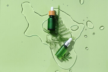 Wall Mural - Composition with bottles of essential oil and plant leaves in water on color background