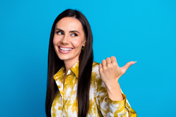 Sticker - Photo of gorgeous cheerful woman wear stylish clothes look empty space billboard isolated on blue color background