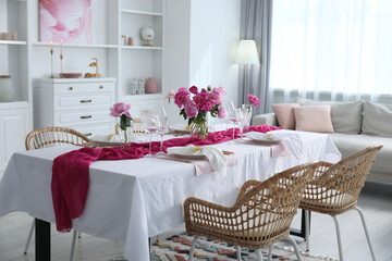 Poster - Beautiful table setting with pink accent and rattan chairs in dining room