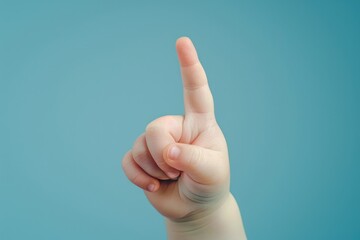 A person pointing their finger at something on a bright blue background