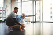 © JorSons/peopleimages.com - Stretching, elderly man and physiotherapist with ball for mobility training, support or muscle workout. Fitness, physiotherapy and senior person with exercise, development or healthcare in retirement