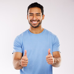 Poster - Thumbs up, smile and asian man in studio, hand gesture and emoji on white background. Thank you, yes and agreement for male person, portrait and happy face for approval and positive feedback or vote