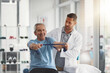 © JorSons/peopleimages.com - Physiotherapist, stretching band and senior patient for consulting, medical care and wellness. Orthopedic, healthcare and chiropractor with person for physical therapy, rehabilitation and exercise