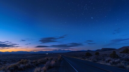 Sticker - A desert highway at dusk, with the sky turning deep blue and the first stars beginning to twinkle above.