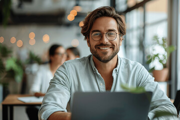 Wall Mural - Smiling Entrepreneur Working on Laptop in Modern Office with Team