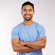 © CineLens2024/peopleimages.com - Crossed arms, smile and portrait of man in studio with confidence for personal trainer career. Pride, happy and face of Asian male gym owner with startup fitness business isolated by gray background.