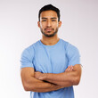 © peopleimages.com - Crossed arms, serious and portrait of man in studio with confidence for personal trainer career. Pride, strong and face of Asian male gym owner with startup fitness business by white background.