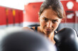 © Wavebreak Media - Fit young Caucasian woman training at the gym, focused on boxing