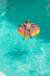 © Wavebreak Media - African American boy enjoys a sunny day in the pool, with copy space