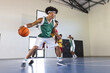 © Wavebreak Media - Young African American man plays basketball indoors