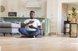 © Wavebreak Media - African american man practicing yoga meditation on floor at home, touching chest, copy space