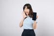 © Jirawatfoto - Announcement online new. excited asian woman expression shouting announce gesture while holding smartphone isolated on white background. attractive female amazed speak cheering discount advertisement.