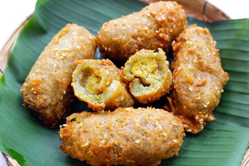 Wall Mural - Deep-fried banana rolls with unripe rice grain