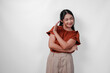 © Reezky - Attractive young Asian woman wearing brown shirt with hand gesture pose rejection or prohibition with copy space over white background.