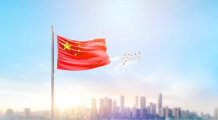 Wall Mural - China national flag waving with skyline and buildings. A beautiful view of flag with skyline.