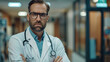 © 沈军 贡 - A male doctor stood with his hands crossed in the hallway of the hospital, in his office