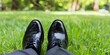 © Anastasiia - Businessman Sitting Barefoot in Park with Black Shoes Next to Him - Copy Space. Concept Businessman, Park, Barefoot, Shoes, Copy Space