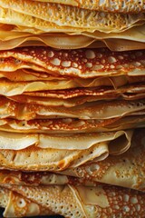 Wall Mural - A stack of thin, golden-brown crepes arranged neatly