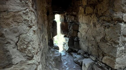 Wall Mural - A view from inside the Genoese fortress in Feodosia, Russia. Looking out through a narrow opening in the thick stone walls.