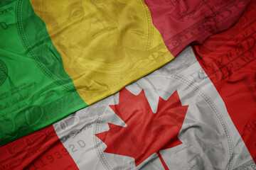 Wall Mural - waving colorful flag of mali and national flag of canada on the dollar money background. finance concept.