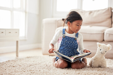 Canvas Print - Toy, playing and kid reading book in home for learning, pretend and knowledge together on floor. Education, teddy bear and girl on carpet storytelling for fairytale, fantasy or child development