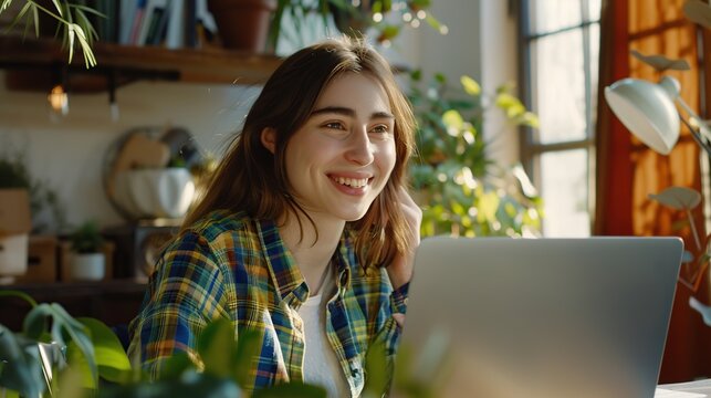 Happy young woman student having video call on laptop computer. Image of beautiful girl play notebook.