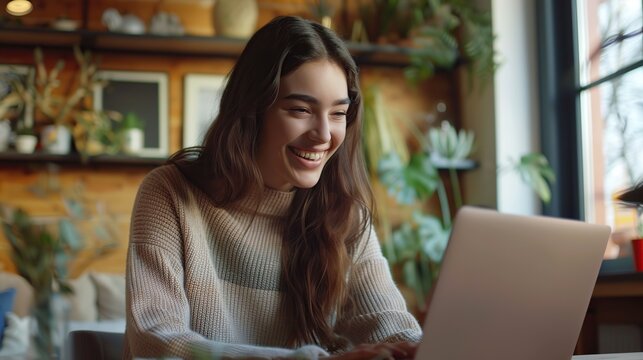 Happy young woman student having video call on laptop computer. Image of beautiful girl play notebook.