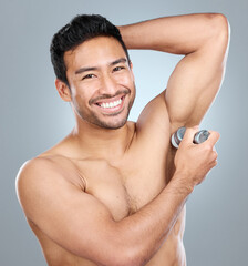 Poster - Beauty, grooming and deodorant of masculine man in studio on gray background for cosmetic wellness. Dermatology, natural and roll on with face of confident person in bathroom for hydration or hygiene