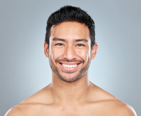 Poster - Beauty, portrait and smile of masculine man in studio on gray background for cosmetic wellness. Dermatology, happy and skincare with face of confident person in bathroom for hydration or hygiene