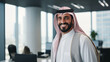 © Beshr - A businessman with arab features smiling and standing at the office