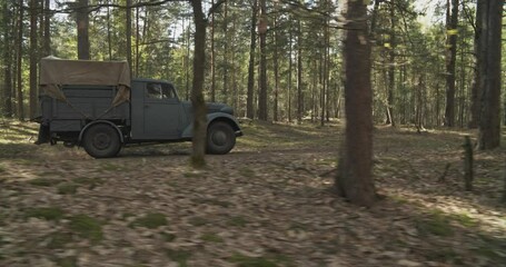 Wall Mural - German Vehicle Truck Opel Blitz Driving By Forest Road. Sunny Autumn Day. Military Truck Opel. German Wehrmacht World War Ii Military Automotive. Autumn Season Nature. Reenactment Tactic Game