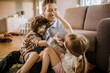 © Vorda Berge - Happy father playing with son and daughter at home