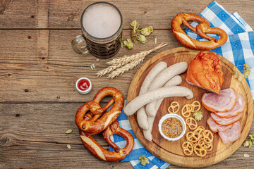 Wall Mural - Traditional Oktoberfest set. Pretzels, beer, weisswurst, eisbein with mustard. German festival food