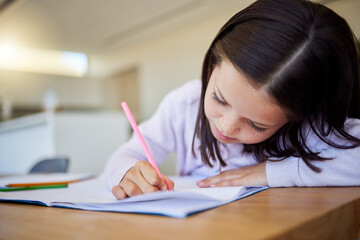 Poster - Child, writing and notebook for education at house with creative learning, drawing or motor skills development. Girl, paper and stationery for art sketch, assessment and homework activity in lounge