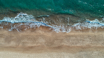 Wall Mural - Patara beach. Photo of waves of clear sea water hitting the shore. The sea containing many colors such as white, green and yellow. Kas, Turkey.