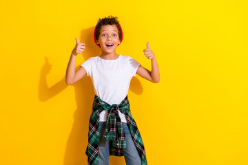 Sticker - Photo portrait of cute little boy thumb up excited dressed stylish white clothes isolated on yellow color background